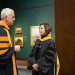 Two faculty members engaged in captivating conversation